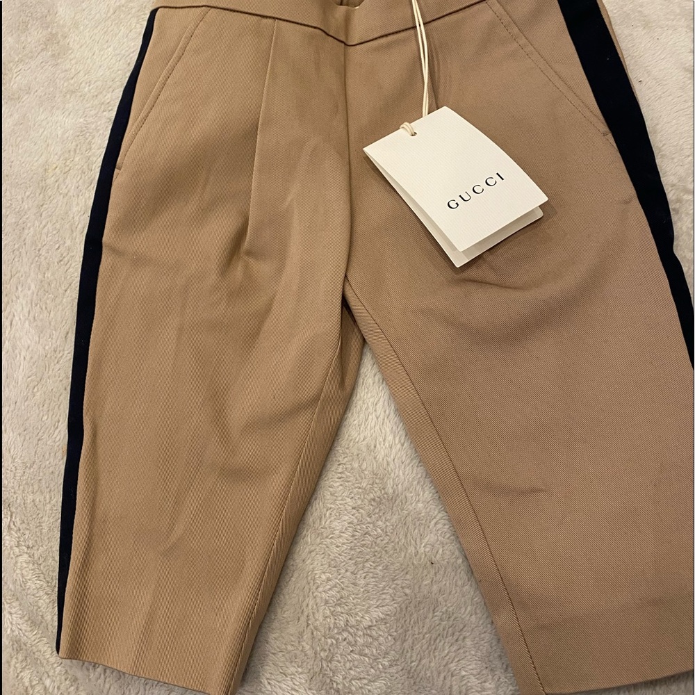 Khaki pants with blue stripes at the side